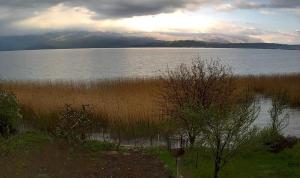 a large body of water with mountains in the background at Krasaqua in Pogradec