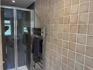 a bathroom with a shower and a tile wall at Forth, Pittenweem in Pittenweem +29 photos