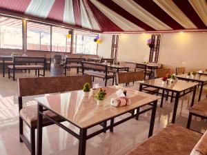 a restaurant with tables and chairs in a room at Wadi rum trips in Wadi Rum