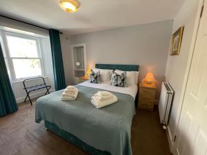 a bedroom with a bed with two towels on it at Forth, Pittenweem in Pittenweem