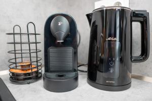 affeepot sitting on a counter next to a coffee maker at Pod Hajom 101 in Liptovský Mikuláš