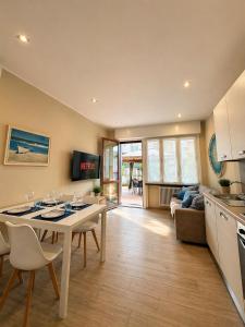 a kitchen and living room with a table and chairs at BiloVarazze with Terrace in Varazze