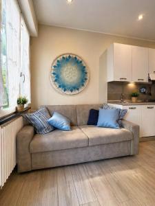 a living room with a couch and a kitchen at BiloVarazze with Terrace in Varazze +10 photos