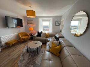 a living room with a couch and a table at Forth, Pittenweem in Pittenweem