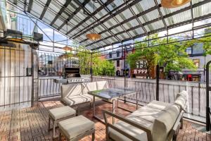 a patio with couches and a table on a building at Theatre Hotel by Lodgo in Montreal
