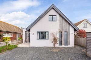 a white house with a black roof at Saoirse in East Wittering
