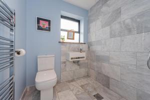 a bathroom with a toilet and a sink at Saoirse in East Wittering +17 photos