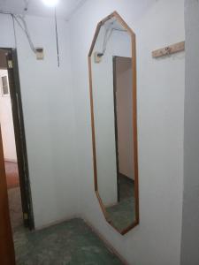 a mirror hanging on a wall in a room at Departamentos y Cuartos Apaxco in Apaxco de Ocampo