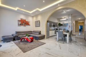 a living room with a couch and a table at Staytopus St Elizabeth - Modern Apartment - in Xewkija