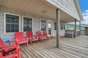 a group of red chairs sitting on a deck at No Worries in Oak Island