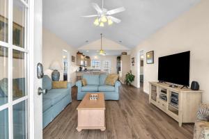a living room with a blue couch and a tv at No Worries in Oak Island