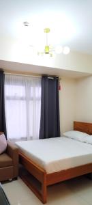 a bedroom with a large bed and a window at The Radiance Manila Bay Studio 2 in Manila +30 photos