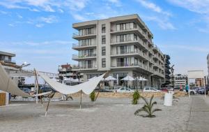a building on the beach with a hammock in front at Lemon Cliff Luxury B&B in Mamaia Sat/Năvodari +21 photos