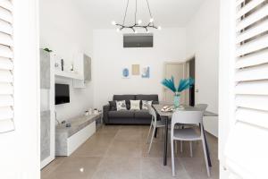 a living room with a table and a couch at La Casetta al mare in Balestrate