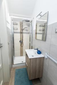 a bathroom with a sink and a shower at La Casetta al mare in Balestrate +17 photos