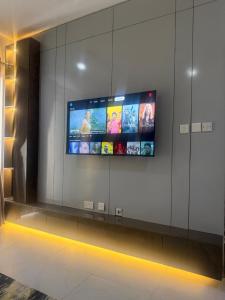 a flat screen tv on a wall in a building at Max Heights, 2 Captivating Bedrooms in Ikeja