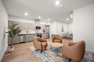 a living room with two chairs and a table at Le Nomade Quartier Chinois in Montreal +253 photos