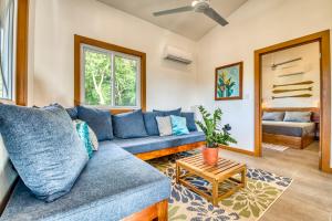 a living room with a blue couch and a table at TropicalArts Resort&Studios in Bocas Town +125 photos