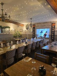 a dining room with tables and chairs and lights at Royal Oak Braithwaite in Keswick +13 photos