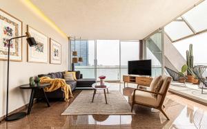 a living room with a couch and a tv at Casa Reforma by Kukun in Mexico City