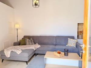 a living room with a blue couch and a table at Estia Vouni Boutique Houses in Vouni