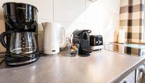 a kitchen counter top with a coffee maker and a coffee pot at Gemütliches Apartment am Bad Muskauer Park Sauna zu buchbar Hunde willkommen Ruhige Lage in Bad Muskau +30 photos
