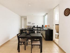 a dining room with a table and chairs and a kitchen at Departamento Harmony Xalapa in Xalapa +19 photos