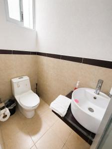 a bathroom with a white toilet and a sink at Departamento Harmony Xalapa in Xalapa