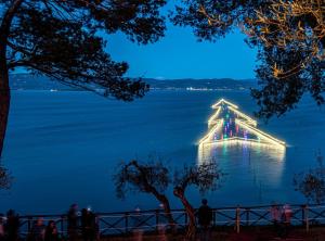 a large boat in the water at night at Al Civico 23 in Castiglione del Lago +21 photos