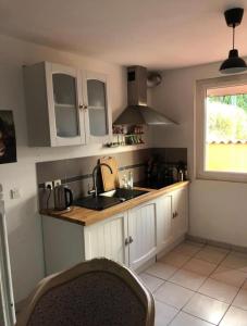 a kitchen with white cabinets and a sink and a window at Maison de ville quartier saint-pierre in Brest