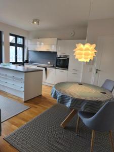 a kitchen with a table and a kitchen with white cabinets at Am Schlosspark Potsdam in Potsdam