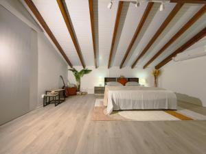 a large bedroom with a bed and wooden ceilings at Villa Serenity in Les Abymes