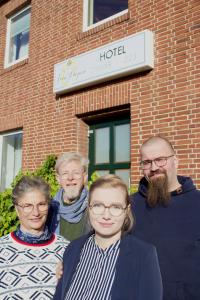 a group of people standing in front of a brick building at Landhotel Vosse-Schepers in Rhede
