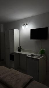 a small kitchen with a counter and a refrigerator at Villa art colony in Ohrid