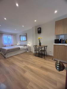 a bedroom with a bed and a table and a kitchen at Putti giocosi in Genoa