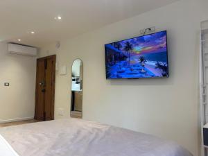 a flat screen tv hanging on a white wall at Putti giocosi in Genoa