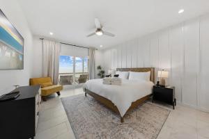 a bedroom with a bed and a desk and a chair at North Topsail Beach - Beachfront, Pool & HotTub in North Topsail Beach
