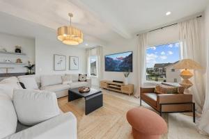 a living room with a couch and a table at North Topsail Beach - Beachfront, Pool & HotTub in North Topsail Beach
