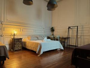 a bedroom with a bed and a desk and a table at Casamor in Buenos Aires