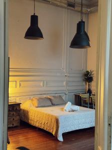 a bedroom with two pendant lights and a bed at Casamor in Buenos Aires