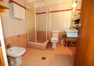 a bathroom with a shower and a toilet and a sink at Myrtus House in Kato Loutraki +14 photos