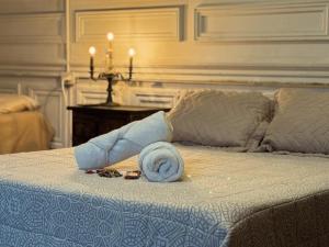 a towel on a bed with a rolled up towel at Casamor in Buenos Aires