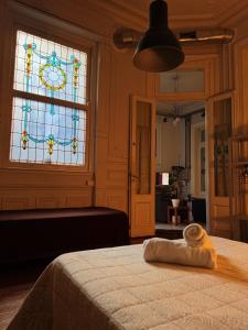 a bedroom with a bed and a stained glass window at Casamor in Buenos Aires