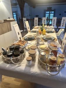 a table with food and drinks on top of it at Chambres d'hôtes les Boulommiers in Samois-sur-Seine
