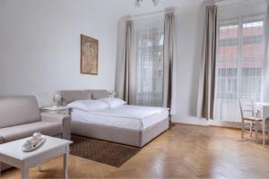 a living room with a bed and a couch at Three Golden Crowns Apartments in Prague
