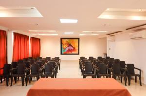 an empty room with chairs and a painting on the wall at Hotel León Dorado in Bucaramanga
