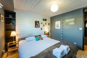 a bedroom with a large white bed with two pillows at Ainos Louanges - Bail Partner in Auxerre
