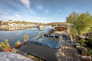 a hot tub on a dock next to the water at Ainos Louanges - Bail Partner in Auxerre