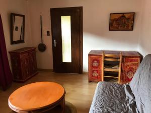 a living room with a couch and a table and a door at Maison Schmidt in Oderen +1 photo