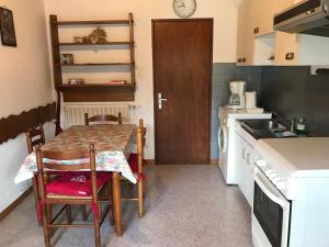 a small kitchen with a table and a sink at Maison Schmidt in Oderen